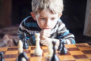 Little boy playing chess